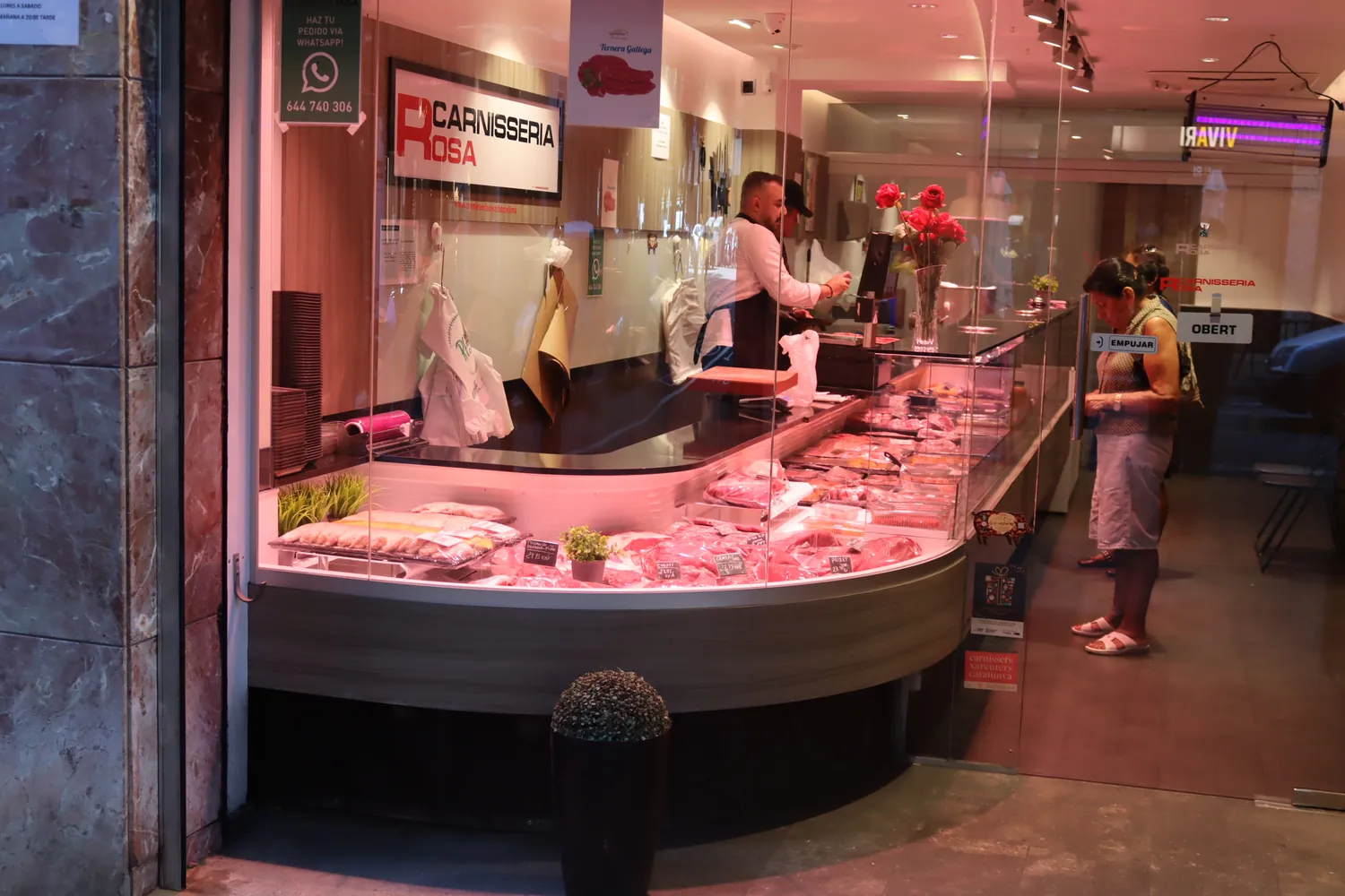Fachada de Carnisseria Rosa con el mostrador lleno de producto